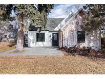 Renovated craftsman home with white siding and brick accents at 9393 W 14Th Ave, Lakewood, CO 80215