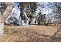 Charming craftsman home with a spacious front yard and mature trees at 9393 W 14Th Ave, Lakewood, CO 80215