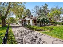 Charming single-story home with mature trees and a well-maintained yard at 1051 Independence St, Lakewood, CO 80215