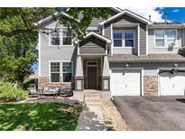Charming townhome with a well-maintained front yard and welcoming entrance at 4797 Flower St, Wheat Ridge, CO 80033
