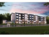 Modern apartment building featuring a combination of gray and dark blue exterior and well-maintained green lawn at 485 Interlocken Blvd # 106, Broomfield, CO 80021