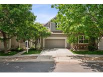 Charming home with a two-car garage, well-manicured lawn, mature trees, and a welcoming entrance at 6024 W Colorado Ln, Lakewood, CO 80232