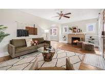 Cozy living room features a fireplace, ceiling fan, and stylish decor at 2318 S Lincoln St, Denver, CO 80210