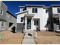 Two-story home showcasing stone accents, large windows, and a modern front door at 22833 E Tufts Ave # A, Aurora, CO 80015