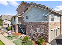 Multi-level exterior showcasing stone accents, stairs to the entrance, and manicured landscaping at 18661 E Water Dr # F, Aurora, CO 80013