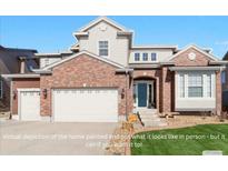 Charming two-story home with a brick exterior, an attached two-car garage, and a well-maintained lawn at 3745 Spanish Oaks Trl, Castle Rock, CO 80108