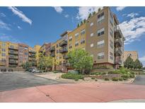 Beautiful condo building with balconies, landscaping, and a well-maintained parking area at 9079 E Panorama Cir # 309, Englewood, CO 80112