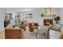Cozy living area with brick fireplace, stylish seating, and an open floor plan at 6620 S Foresthill St, Littleton, CO 80120