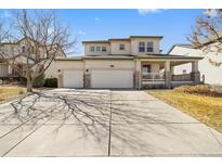 Charming two-story home with a three car garage and a covered front porch at 6445 S Telluride St, Aurora, CO 80016