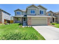 Inviting two-story home features a well-manicured lawn and attached two-car garage at 5394 S Gray St, Littleton, CO 80123