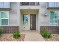 Inviting home entrance with a modern door, brick accents, and well-maintained landscaping at 8711 E Hampden Ave # 26, Denver, CO 80231
