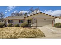 Charming one story home with a brick exterior, well-maintained lawn, and an attached two car garage at 8195 Field Ct, Arvada, CO 80005