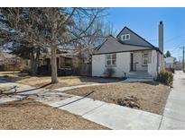 Charming gray and white two-story home with sidewalk leading to the front door at 4022 E 17Th Avenue Pkwy, Denver, CO 80220