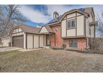 Charming two-story home featuring a well-maintained lawn, brick accents, and a welcoming front entrance at 18251 E Union Dr, Aurora, CO 80015