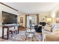 Cozy living room with natural light and comfortable seating arrangement at 2375 S Linden Ct # 118, Denver, CO 80222