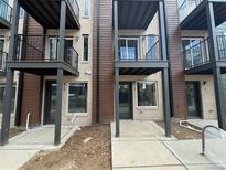Modern townhome exterior featuring private balconies and a contemporary brick and wood facade at 1652 N Lafayette St # 6, Denver, CO 80218