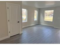 Bright living room featuring large windows, modern floors, and neutral paint tones at 1652 N Lafayette St # 6, Denver, CO 80218
