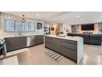 Spacious kitchen with an island and modern appliances, seamlessly connecting to the living area at 1025 Zang St, Golden, CO 80401