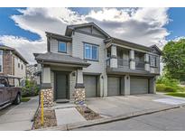 Charming home featuring a two-car garage, a well-manicured lawn, and stone accents at 13151 Grant N Cir # C, Thornton, CO 80241