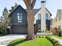 Stunning two-story home featuring manicured lawn, modern design, and a large tree in front at 510 Glencoe St, Denver, CO 80220