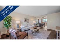 Inviting living room featuring stylish furniture, natural light, and an open floor plan with adjacent dining area at 3744 Miller Ct, Wheat Ridge, CO 80033