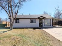 Charming single-story home featuring a well-manicured front yard and attached carport at 992 Toledo St, Aurora, CO 80011