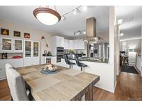 Bright kitchen featuring granite countertops, stainless steel appliances, and a large dining table at 30 Garfield St # B, Denver, CO 80206