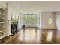 Spacious living room features hardwood floors, a fireplace, and large windows letting in ample natural light at 30 Garfield St # B, Denver, CO 80206