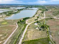 Expansive aerial view of property with surrounding lakes and natural landscape at 14831 Riverdale Rd, Brighton, CO 80602