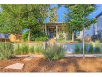 Charming home exterior featuring well-manicured landscaping and mature trees enhancing curb appeal at 1818 S Humboldt St, Denver, CO 80210
