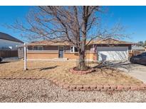 Charming single story home with a brick and siding exterior and a two-car garage at 8909 S Allison St, Littleton, CO 80128