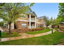 Inviting condo exterior with stone accents, private balcony, and well-maintained landscaping at 8200 E 8Th Ave # 5-204, Denver, CO 80230