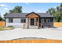 Charming home featuring a striking black and white exterior and a welcoming covered porch entry at 4645 E Florida Ave, Denver, CO 80222