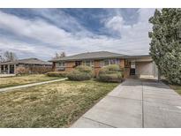 Charming brick home with a covered carport, mature landscaping, and a well-maintained front lawn at 170 S Fenton St, Lakewood, CO 80226
