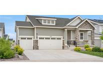 Charming two-story home featuring a three-car garage and stone accents at 5597 Pinto Valley St, Parker, CO 80134