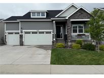 Charming two-story home featuring a three-car garage, stone accents, and well-manicured landscaping at 5597 Pinto Valley St, Parker, CO 80134