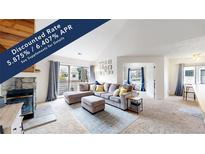 Bright living room features vaulted ceilings, a cozy fireplace, and sliding glass doors at 3600 S Pierce St # 5-202, Denver, CO 80235