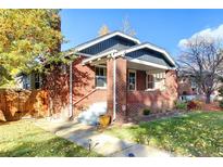 Charming brick home with a welcoming front porch and well-maintained landscaping at 3315 N Stuart St, Denver, CO 80212