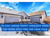 Charming home featuring a three-car garage, gray siding, and a well-maintained front yard at 7633 S Addison Way, Aurora, CO 80016