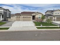 Charming single-story home with well-manicured lawn, three-car garage, and welcoming curb appeal at 10553 Xenia Ct, Commerce City, CO 80640