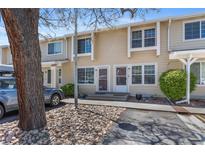 Charming townhome featuring a welcoming entrance and well-maintained landscaping with mature trees at 8915 Field St # 116, Broomfield, CO 80021