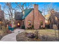 Charming brick home featuring a stone walkway, a cozy front yard, and a welcoming entrance at 357 Birch St, Denver, CO 80220