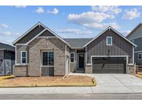 Charming single-Gathering home with a modern design, a gray garage door, and well-maintained landscaping at 8658 Pennycress Dr, Littleton, CO 80125
