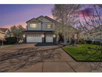 Charming two-story home featuring a three car garage, stone accents, and manicured lawn at 26861 E Clifton Dr, Aurora, CO 80016