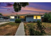 Charming single story home featuring a well-maintained lawn and concrete walkway at 2308 Lima St, Aurora, CO 80010