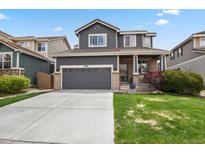 Charming two-story home with a gray facade, well-maintained lawn, and a convenient two-car garage at 16164 E Hinsdale Ave, Aurora, CO 80016