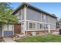 Charming exterior of a two-story townhome with a well-maintained lawn and classic architectural details at 13343 E Louisiana Ave, Aurora, CO 80012