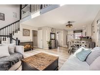 Bright living room with a lofted area, hardwood floors, and modern furnishings at 2890 W Long Cir # A, Littleton, CO 80120
