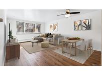 Living room with hardwood floors, natural light, comfortable seating, and dining area at 969 S Pearl St # 103, Denver, CO 80209