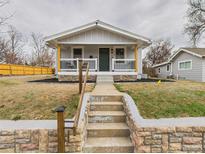 Charming home featuring a quaint porch, stone accents, and a well-maintained front yard at 3150 S Pennsylvania Street, Englewood, CO 80113